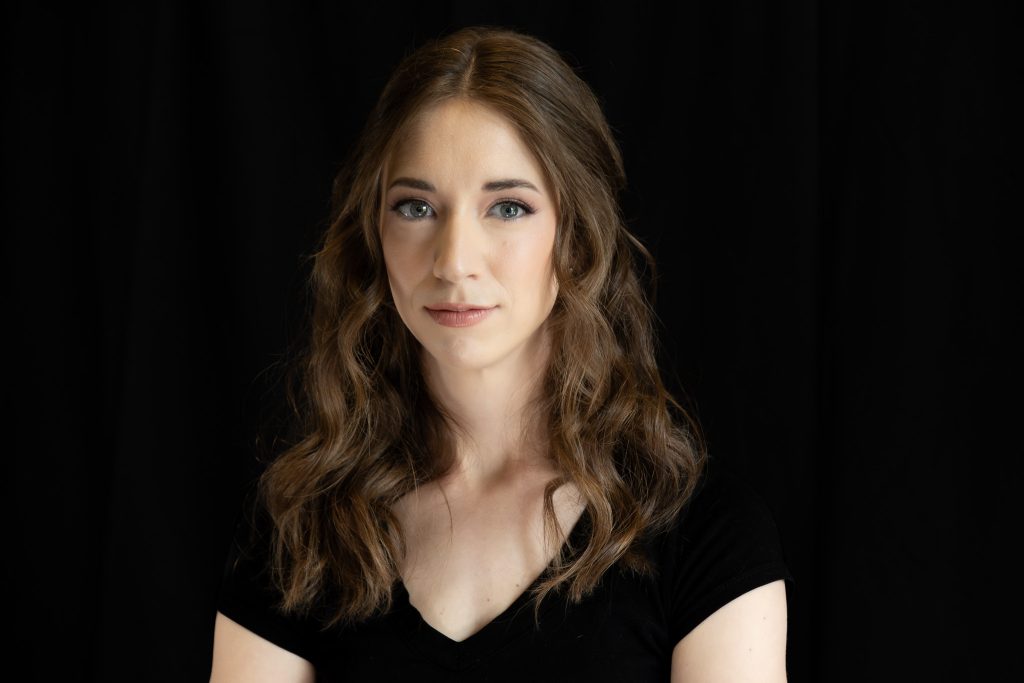 professional studio headshot of a woman against a black background, taken with our mobile studio in Edmonton.